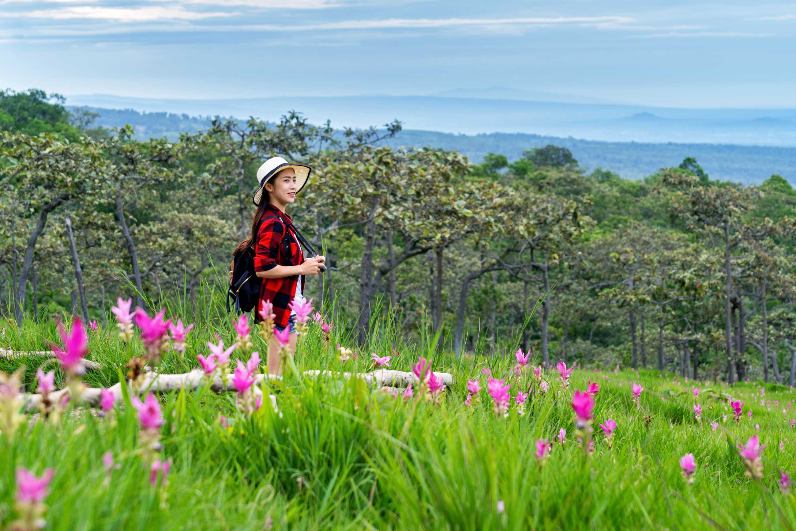 woman-traveler-with-backpack-enjoying-krachiew-flower-field-thailand-travel-conc.jpg